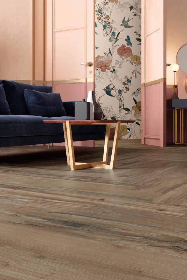 herringbone wood-look porcelain tile in living room with pink double doors and floral wallpaper